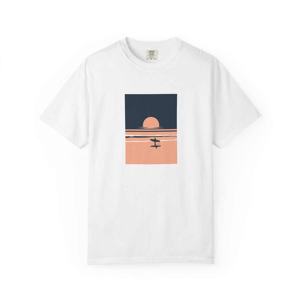 White T-shirt with a blue and peach sunset illustration with waves and a surfer holding a board printed on the front.