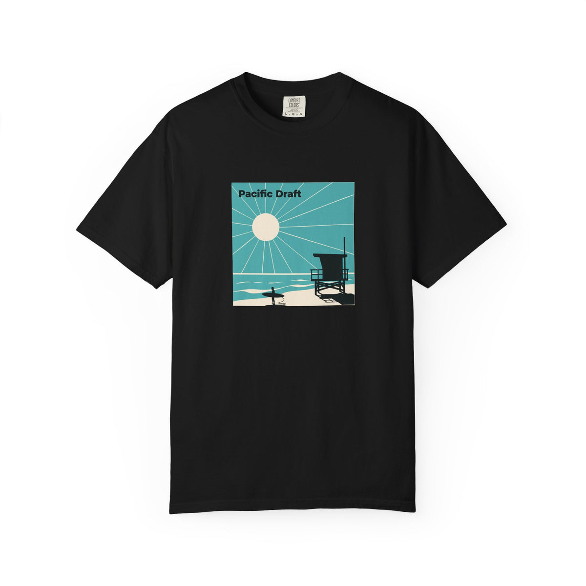 Black T-shirt with a turquoise and cream Pacific Draft panel showing sun rays, a lifeguard tower, and a surfer printed on the front.