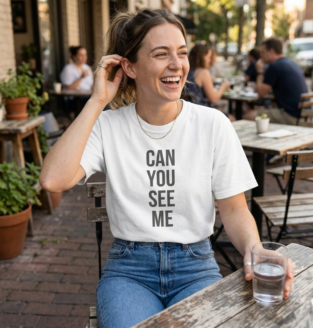Model wearing a Blacksunset T-shirt with the "Can You See Me" design, lifestyle view 1